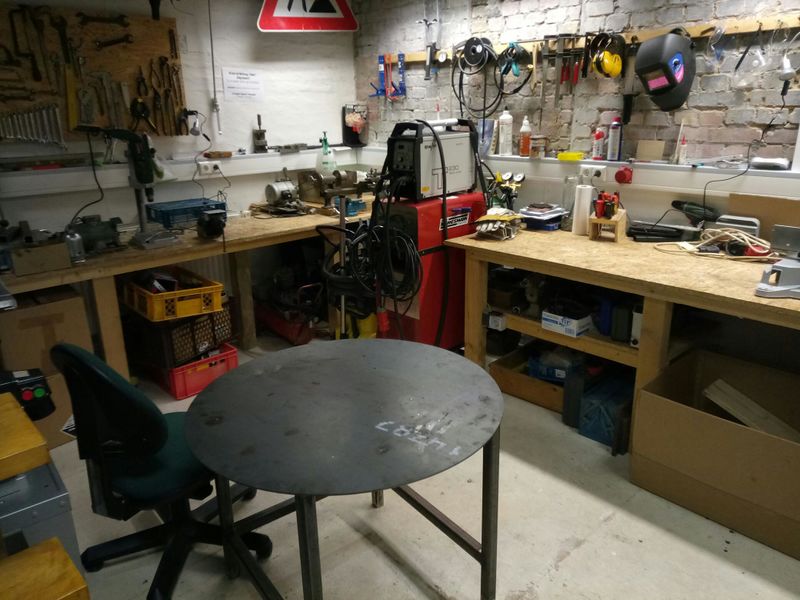 Datei:Werkstatt mit Schweißgeräten und Schweißtisch.jpg